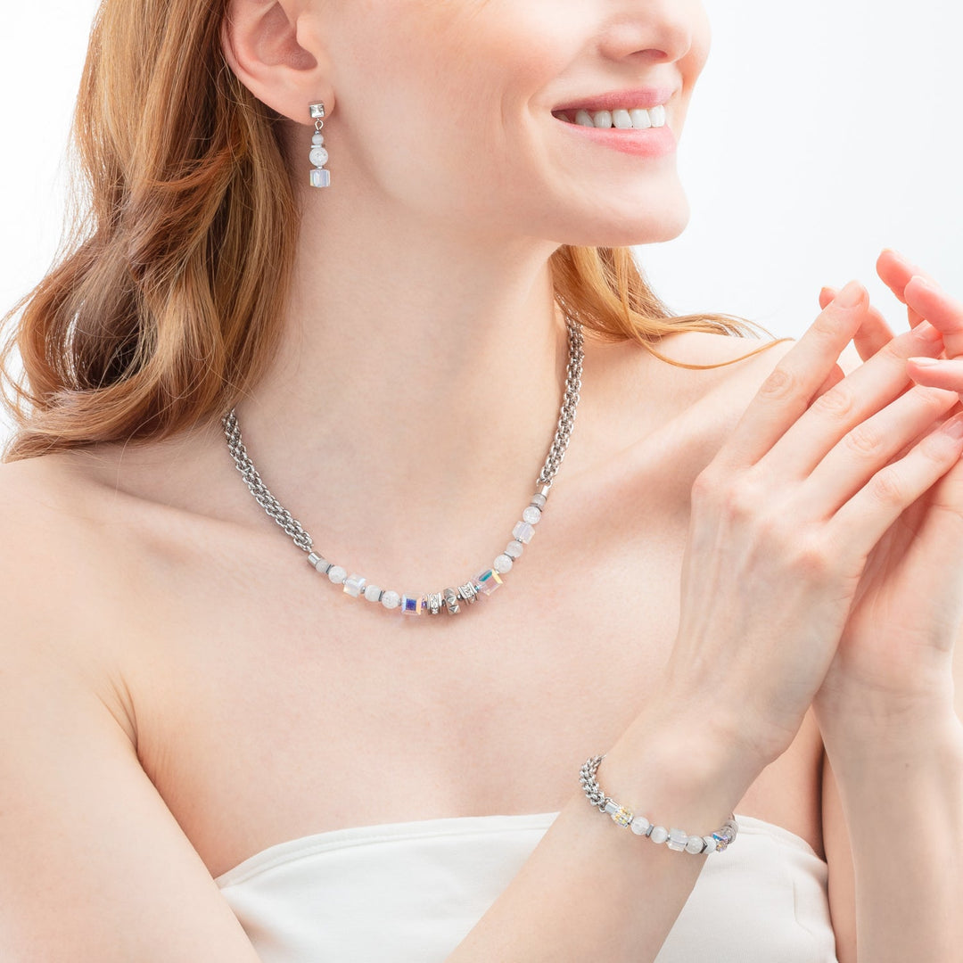 Model wearing Coeur de Lion steel and white crystal necklace, bracelet and earrings - Carathea & Jools