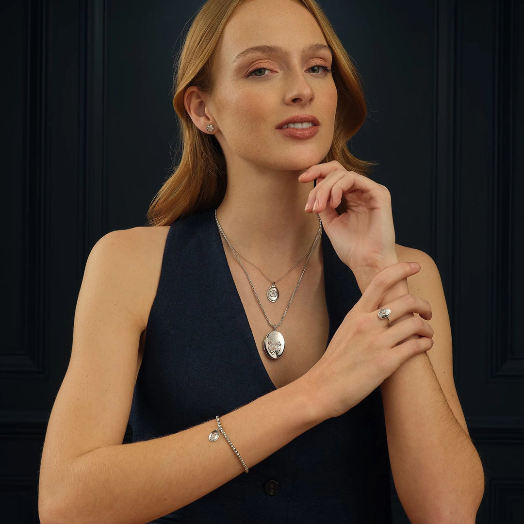clogau gold forget-me-not pendant, locket and earrings on model - Carathea & Jools authorised stockists 