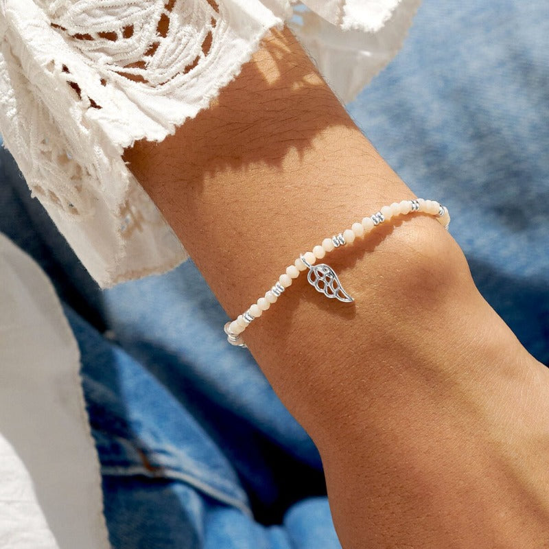 white and silver bead bracelet with wing charm - Carathea