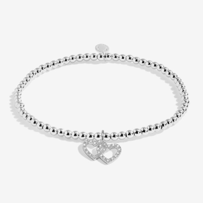 Silver bracelet with two intertwined hearts.