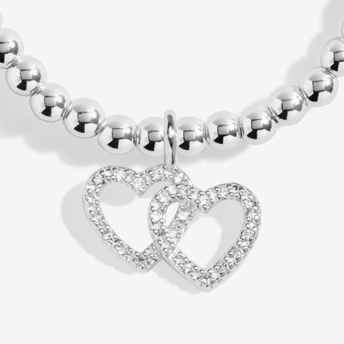 Silver bracelet with two intertwined hearts.