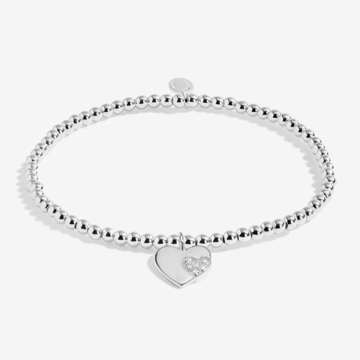 Silver heart charm bracelet on a stretchable beaded strand.