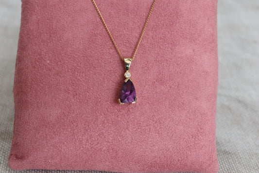 A stunning 9ct gold pendant with a bold, geometric amethyst stone topped with a diamond - Carathea Jewellers