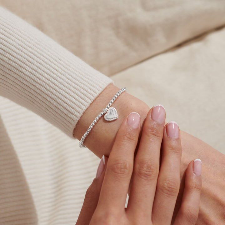 A silver-plated beaded bracelet with heart charm with cz