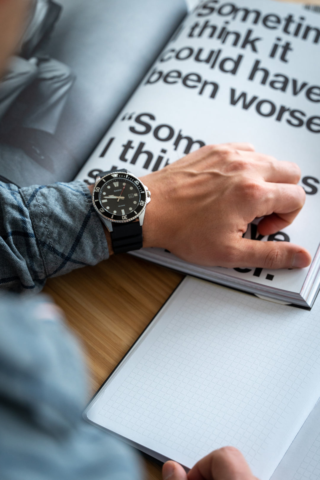 Men's black diver's watch with luminous hands and resin strap.