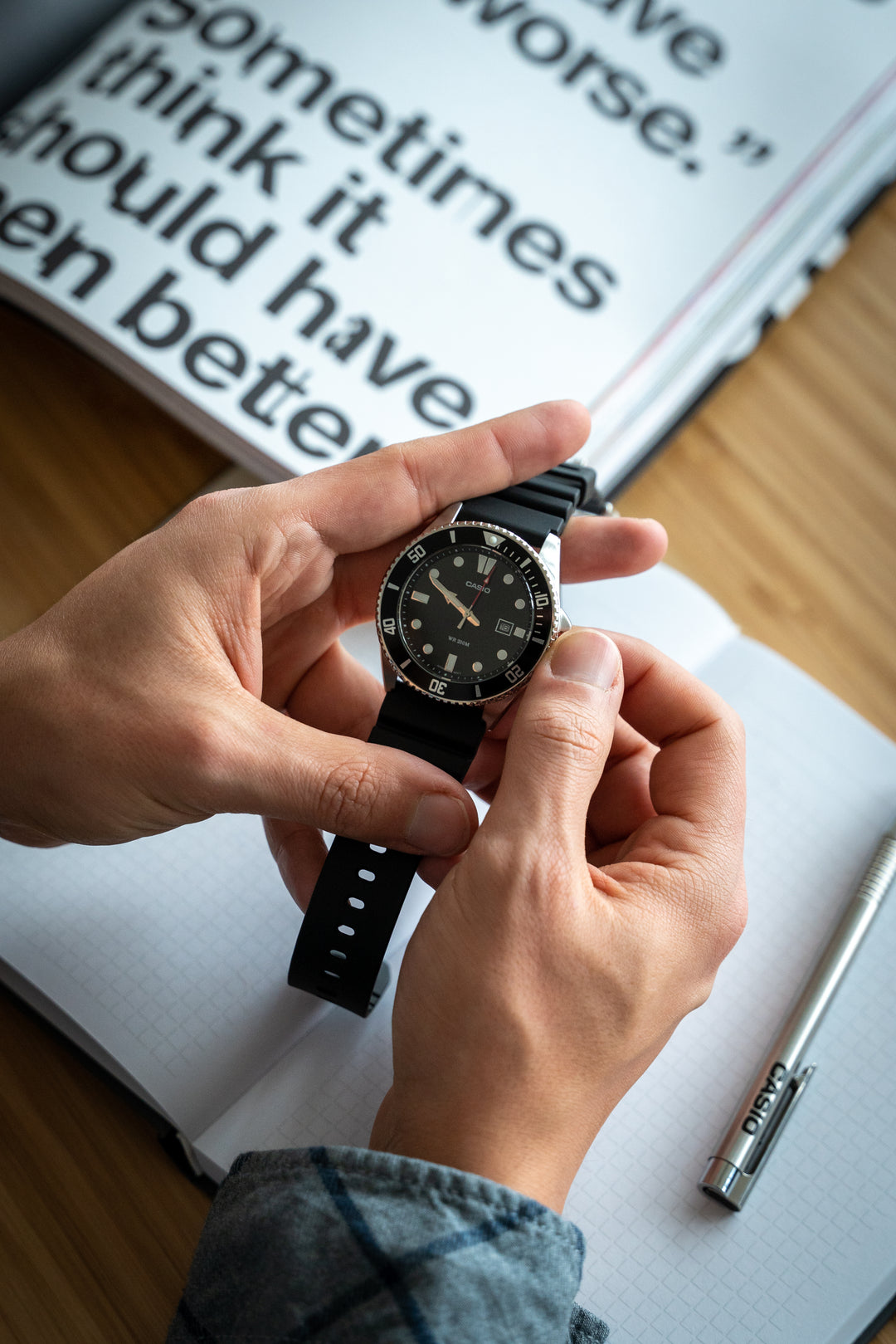Men's black diver's watch with luminous hands and resin strap.
