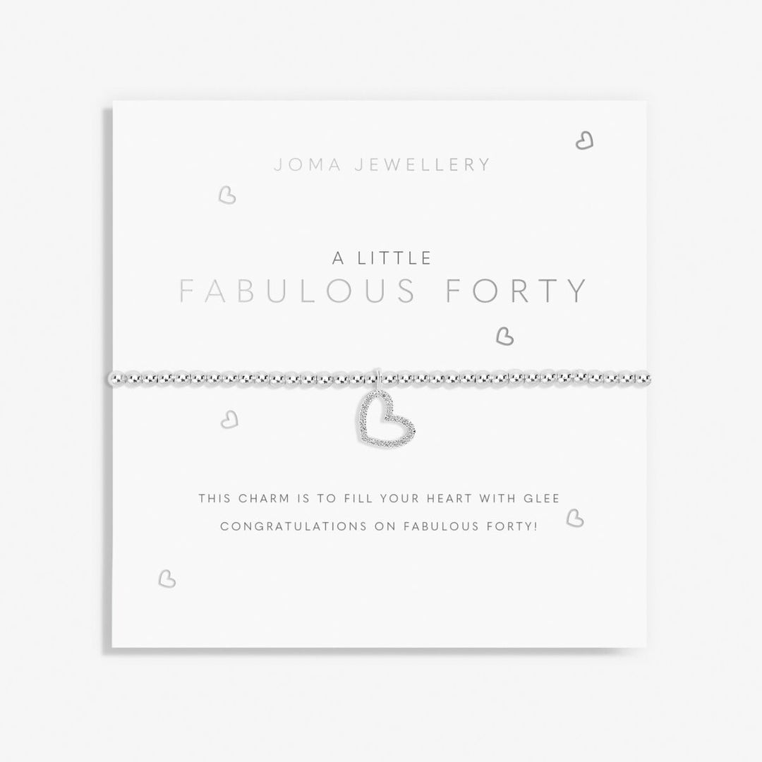 A silver heart charm bracelet by Joma Jewellery, displayed on its white presentation card with the text 'A LITTLE FABULOUS FORTY'.