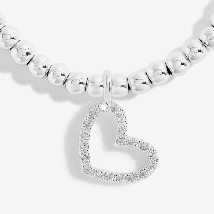 Silver beaded bracelet with a heart-shaped charm on a white background