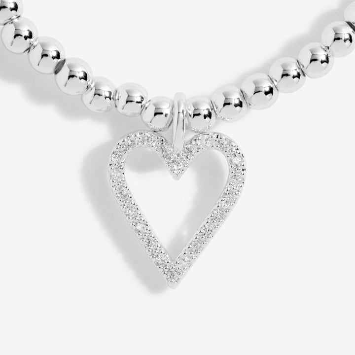 A silver beaded necklace with a heart-shaped pendant paved with small clear stones, shown on a clean white background.