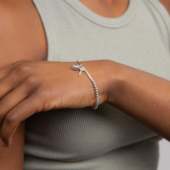 Sterling silver beaded bracelet with heart and key charms.