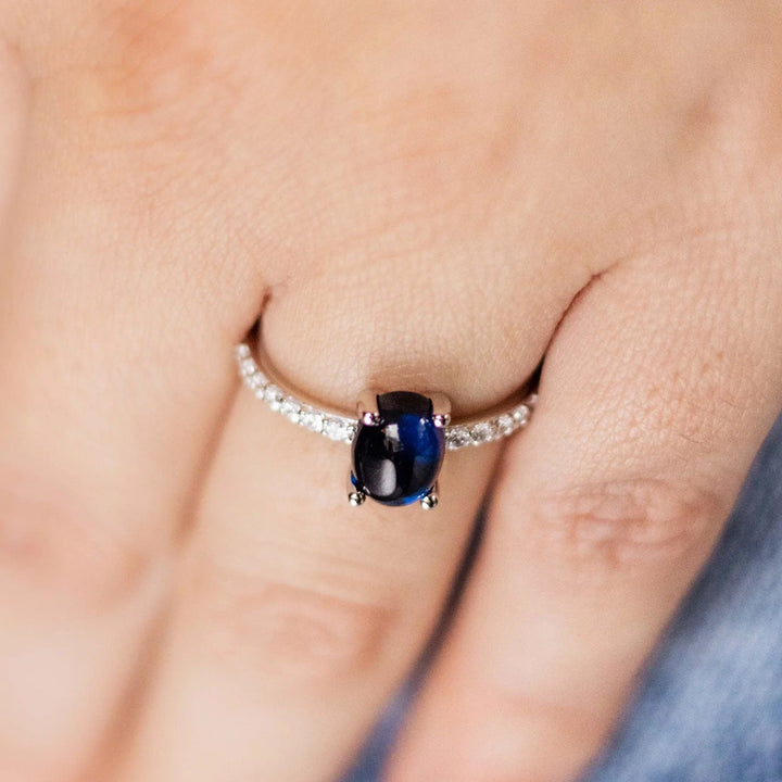 Blue oval stone ring with silver band.