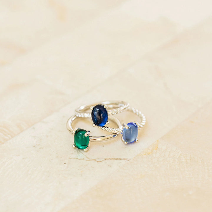 Blue oval stone ring with silver band.