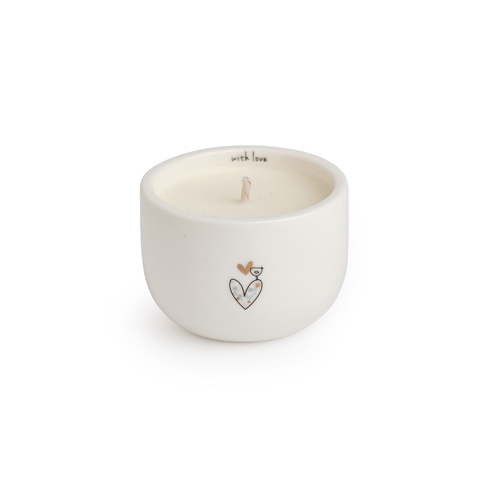 Belly Button With Love candle in a round cream ceramic pot with its message inside the rim and a heart and bird outside.