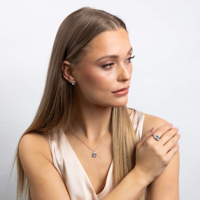 Aquamarine stud earrings with a small clear stone accent.