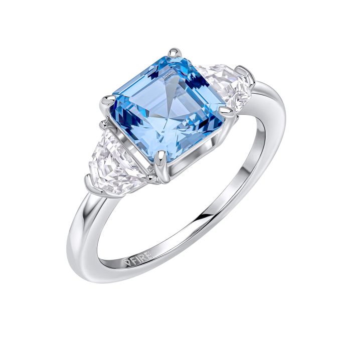 Aquamarine trilogy ring with silver band and zirconia stones.