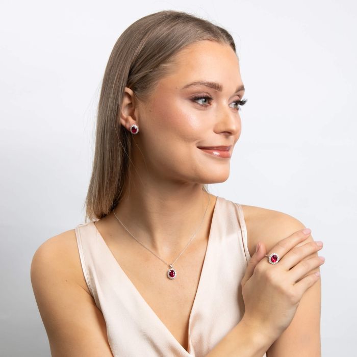 Red zirconia pendant with a halo of clear zirconia on a silver chain.