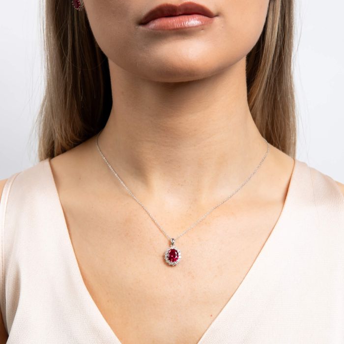 Red zirconia pendant with a halo of clear zirconia on a silver chain.