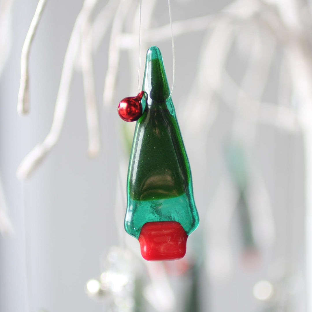 Fused glass Christmas tree ornament with green and red details.