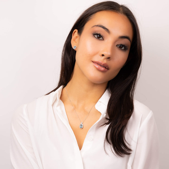 Woman wearing a white shirt with a plain background