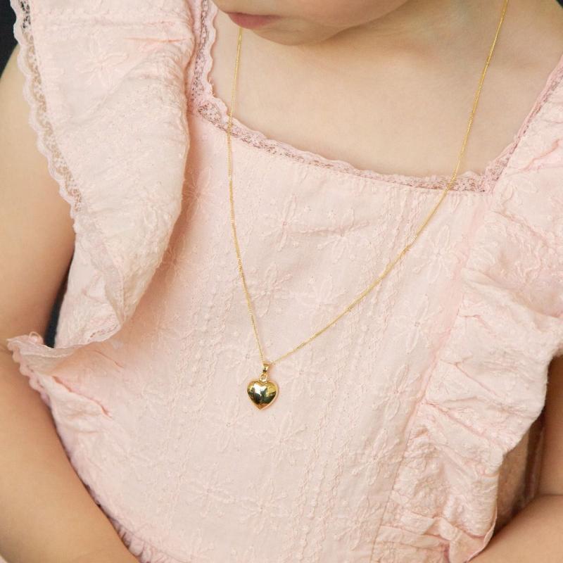 9ct domed heart pendant on child- Carathea jewellers