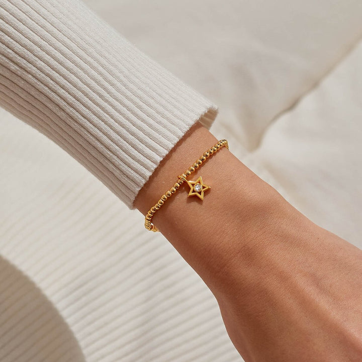 Gold beaded bracelet with a star charm.