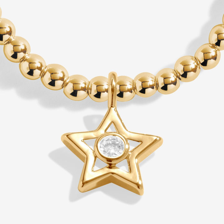 Gold beaded bracelet with a star charm.