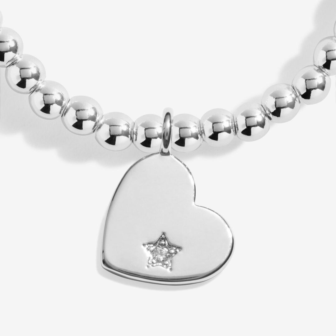 Silver beaded bracelet with a heart charm and gemstone.