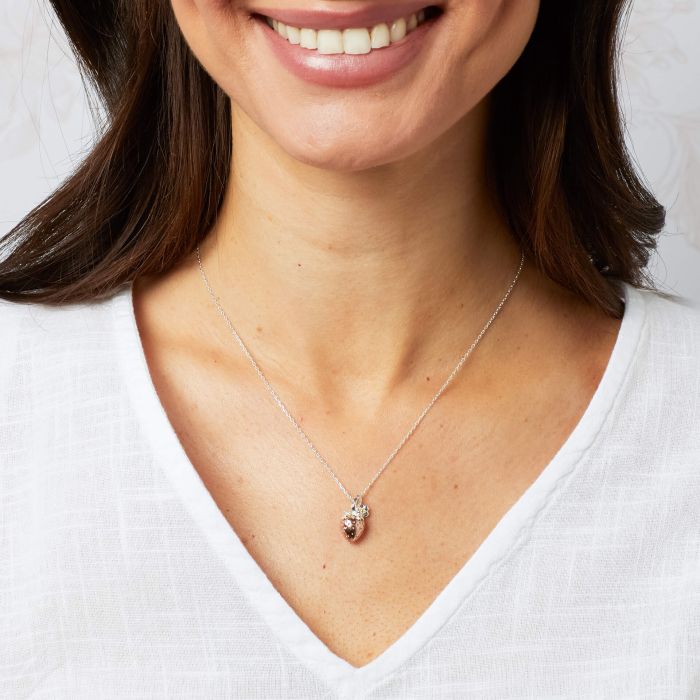 Rose gold strawberry and silver flower necklace.