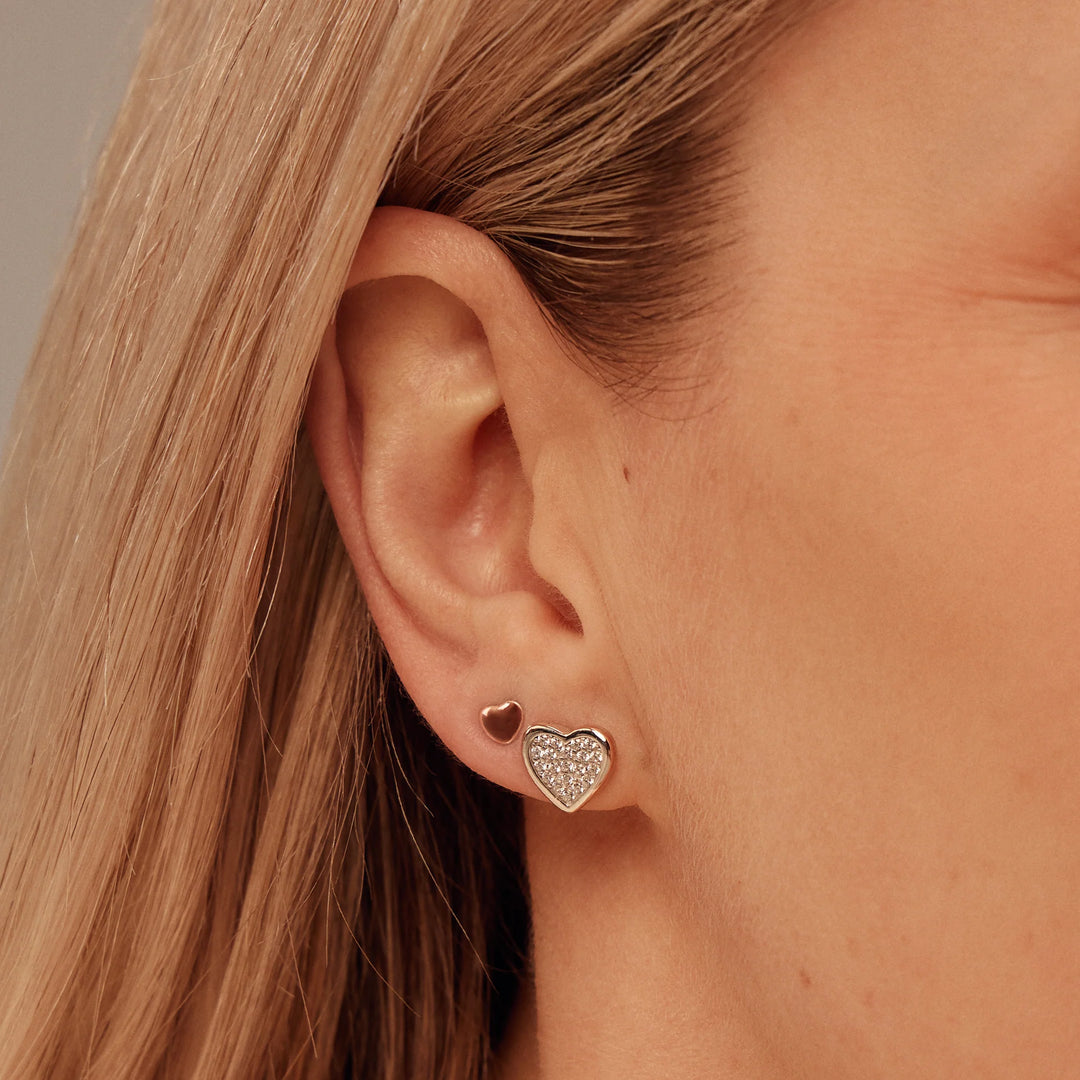 These are rose gold heart earrings made of sterling silver with a touch of rare Welsh gold.