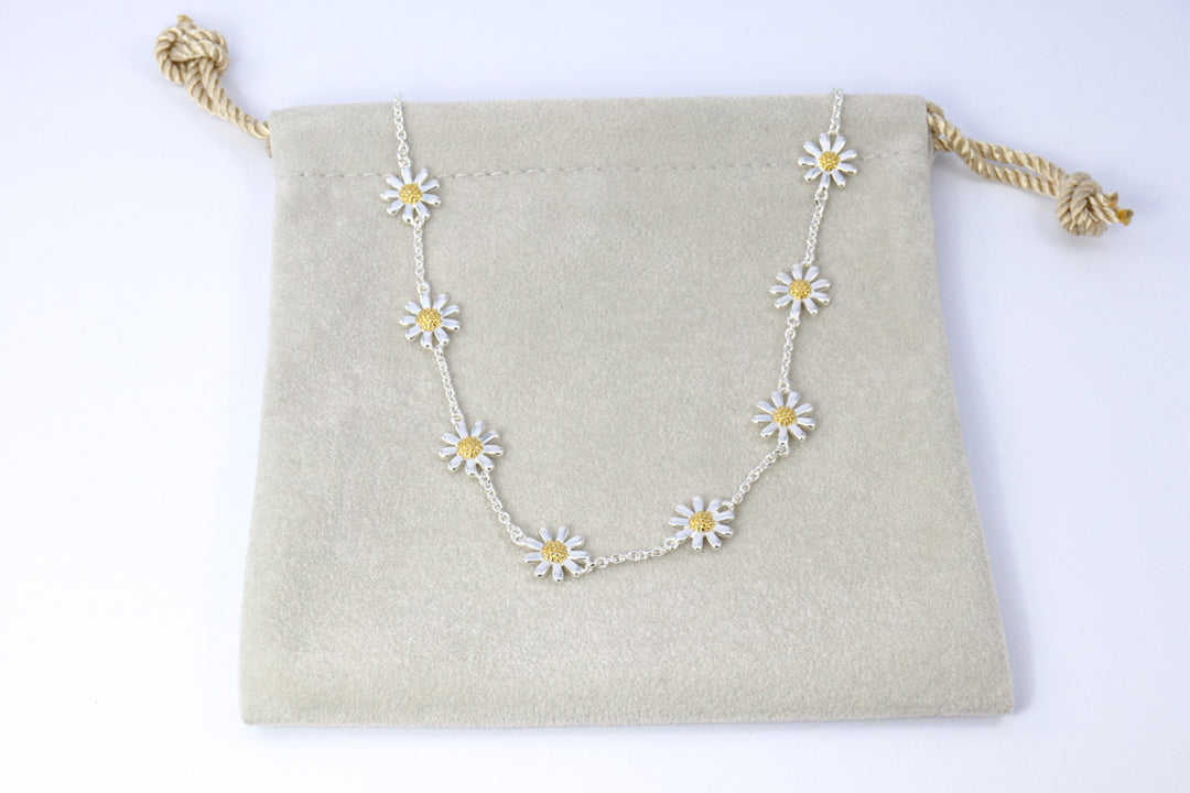 Two-tone daisy necklace with gold and silver flowers.