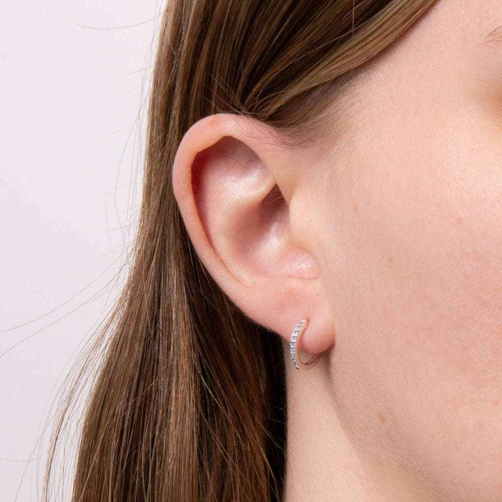 These are lightweight, sparkling, sterling silver hoop earrings plated with platinum and set with cubic zirconia stones - Carathea & Jools