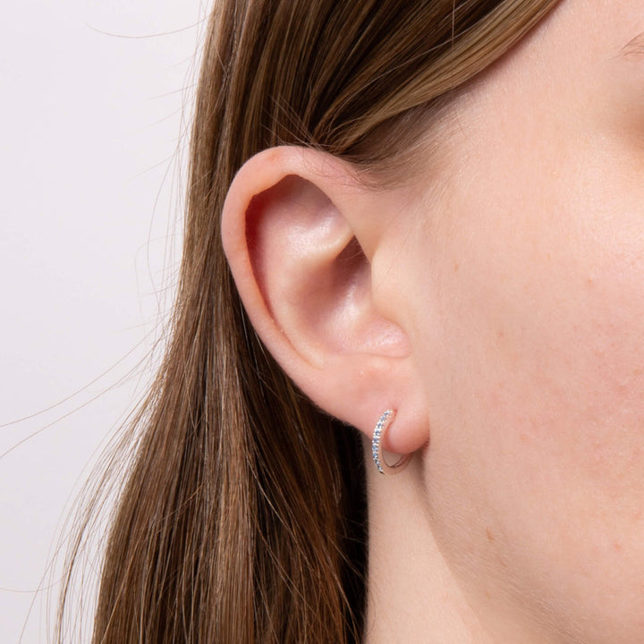 These are lightweight, sparkling, sterling silver hoop earrings plated with platinum and set with cubic zirconia stones - Carathea & Jools