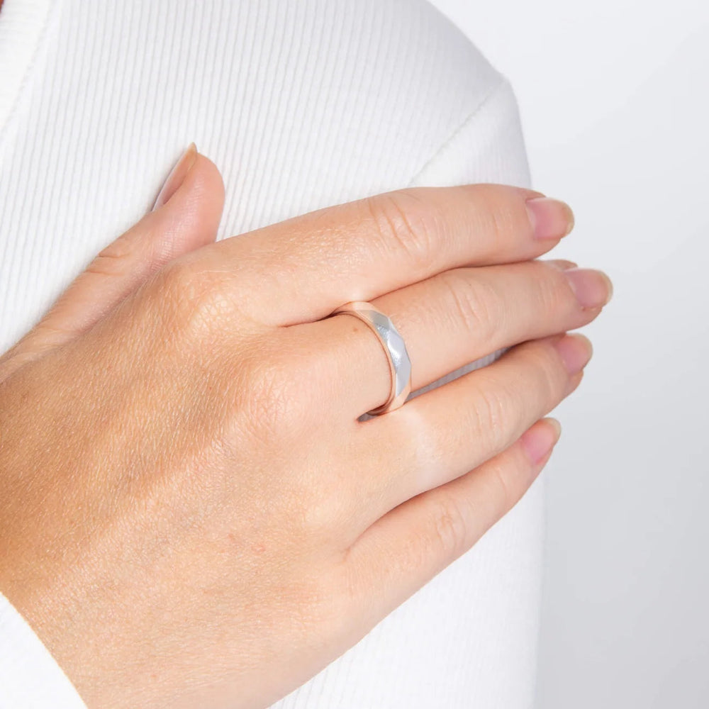 silver hammered ring on model wearing white top