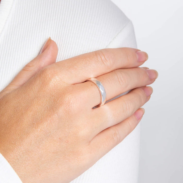 silver hammered ring on model wearing white top