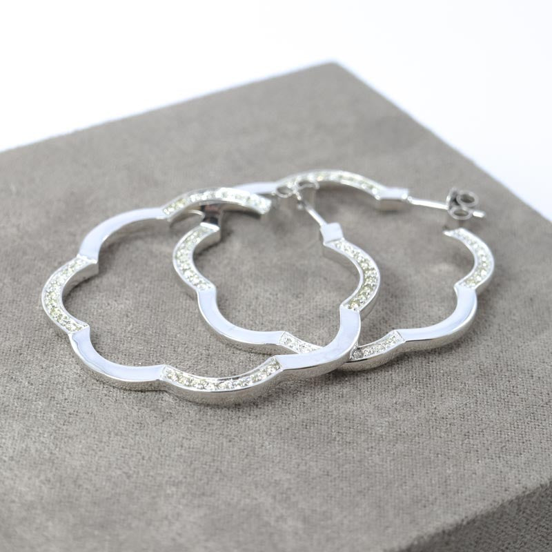Sterling silver cloud hoop earrings with cubic zirconia accents.