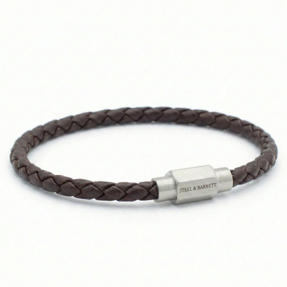 Brown braided leather bracelet with a silver clasp on a white background