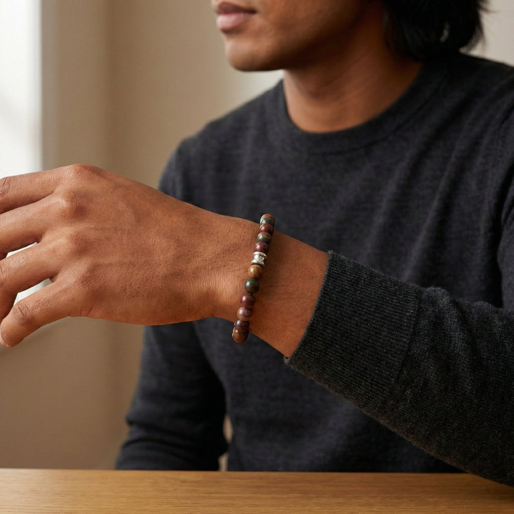 Person wearing a beaded bracelet on a blurred background