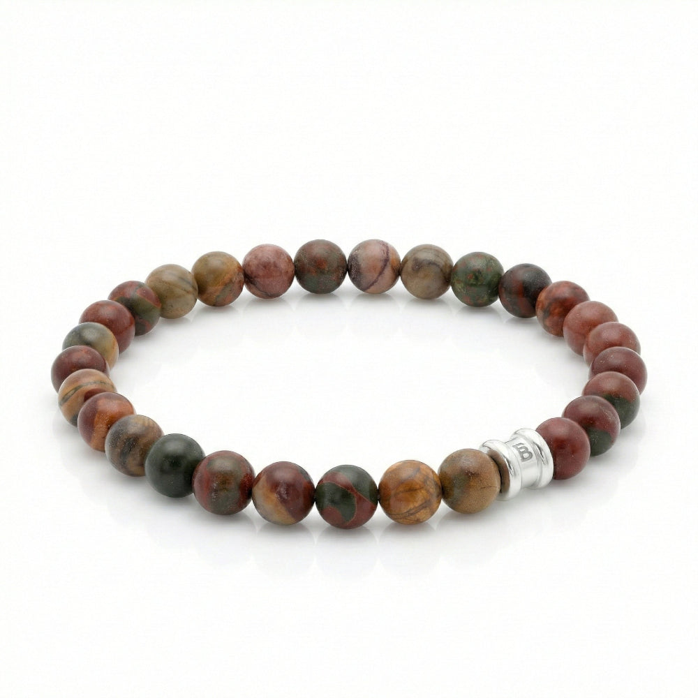 Beaded bracelet with cherry creek jasper beads and a silver charm on a white background