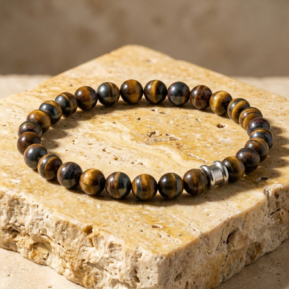 Beaded bracelet with brown and black stones on a stone surface