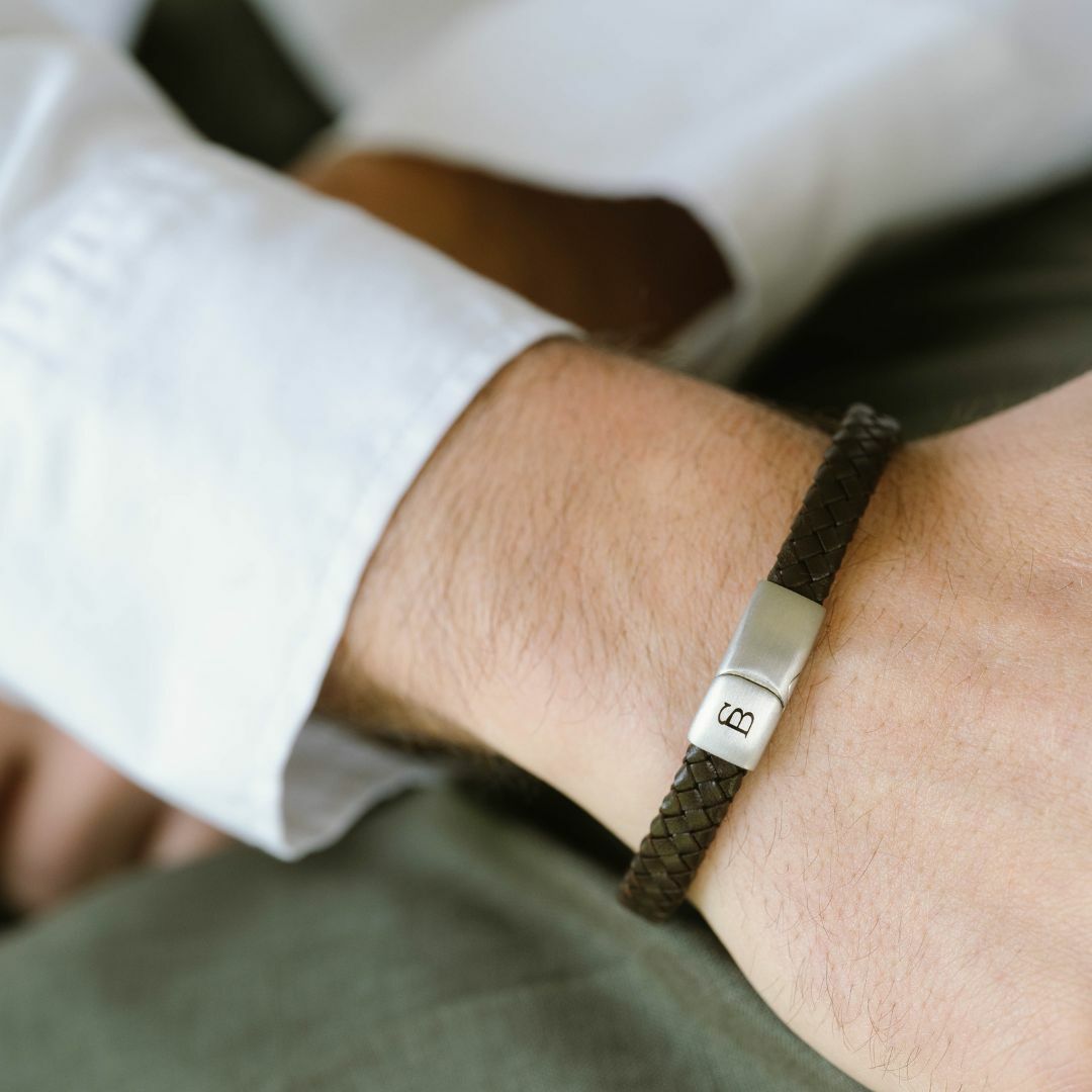 Brown braided leather bracelet with a silver magnetic clasp.