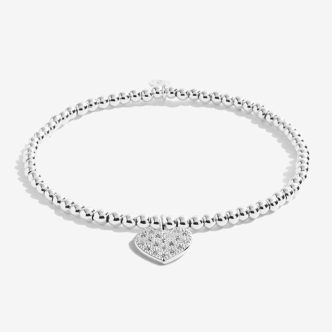 Silver bracelet with a heart-shaped clasp on a white background