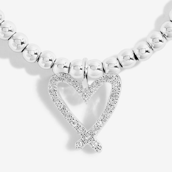 A silver beaded necklace featuring a heart-shaped pendant with a double heart design, both outlined in sparkling clear stones, shown against a light gray background.