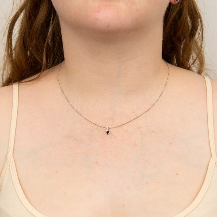 white gold sapphire & diamond pendant on model - Carathea jewellers