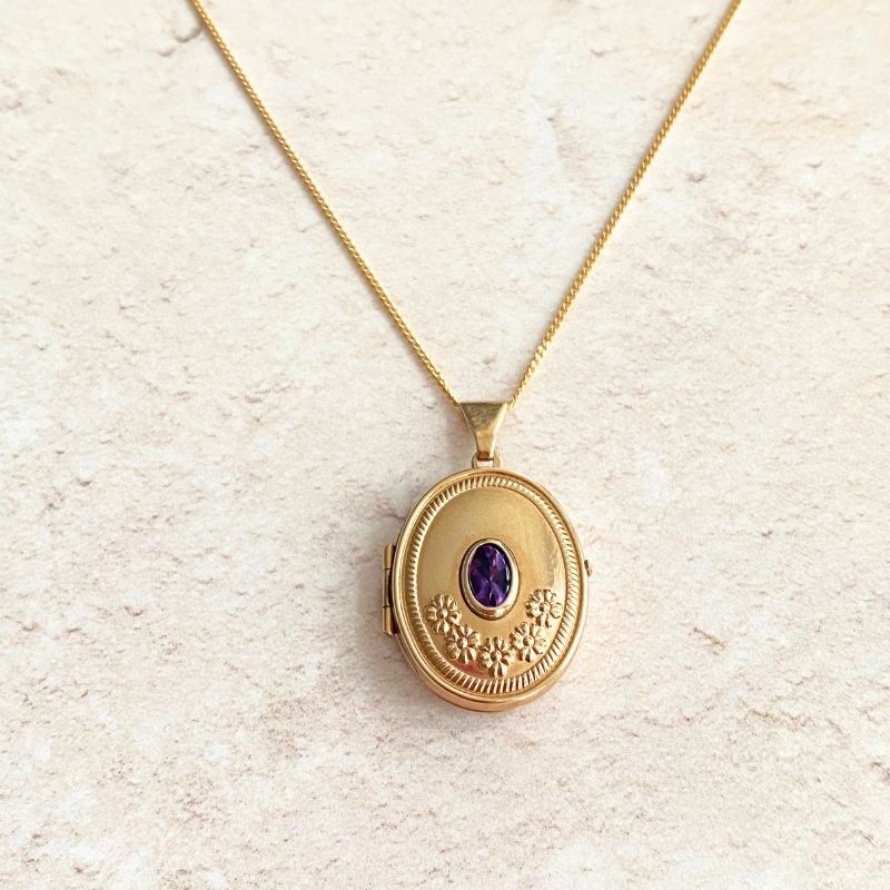 Gold oval locket with amethyst and flowers Carathea jewellers