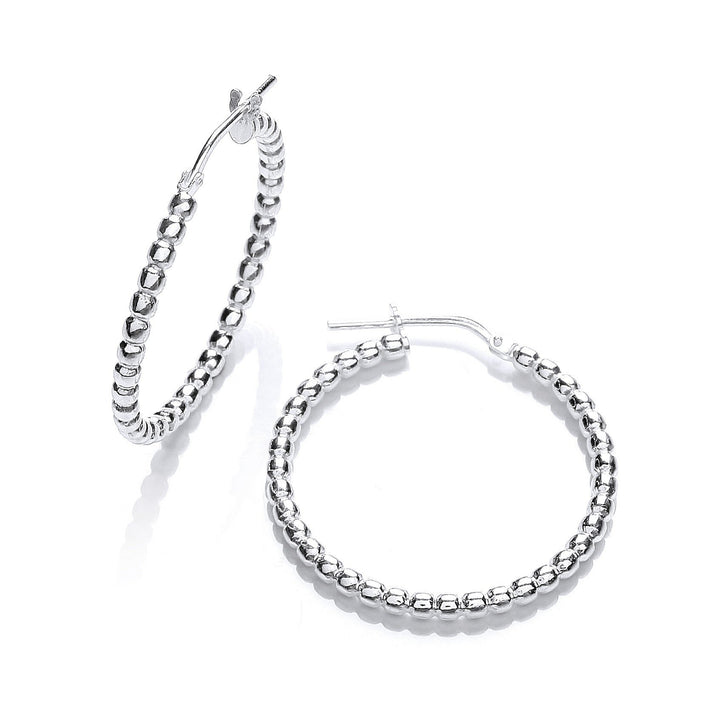 These are sterling silver beaded hoop earrings, fifteen millimeters in diameter, with a beaded design around the outer edge.