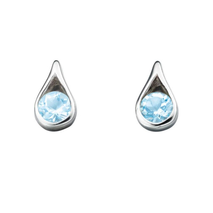 These are polished sterling silver stud earrings with teardrop-cut blue topaz stones, measuring nine by five millimeters | Carathea & Jools