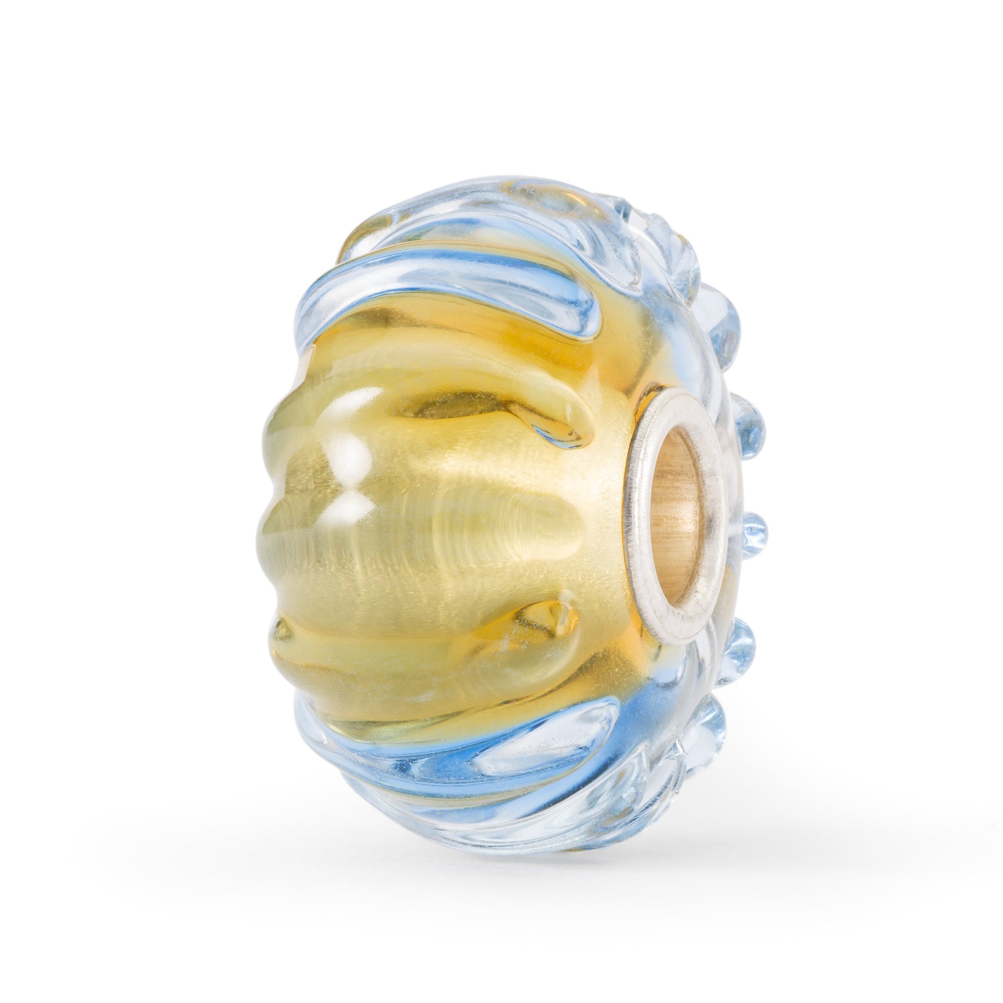 trollbeads water flow glass bead with patterns of ripples of blue waves over a yellow, sandy background