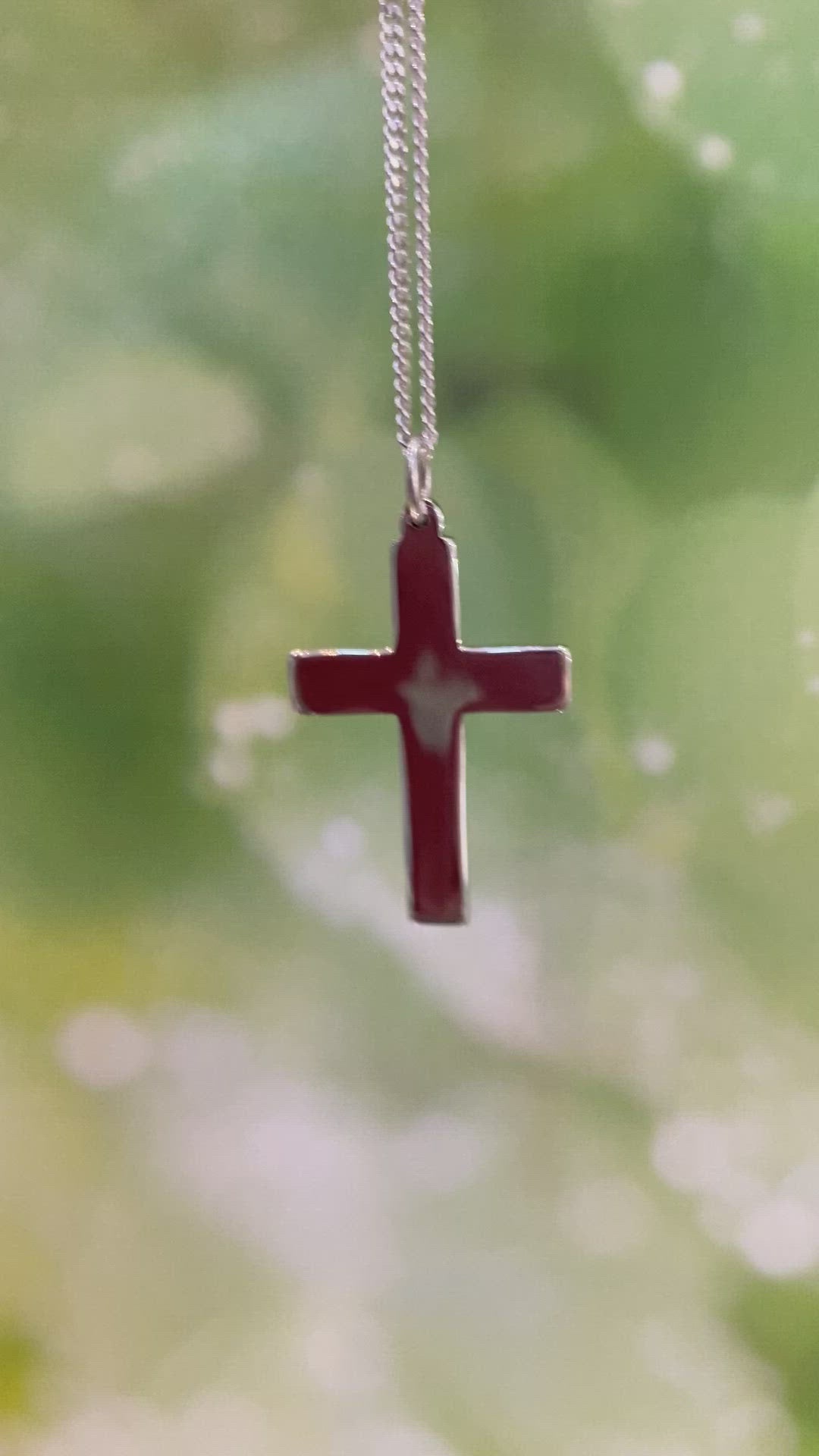 video of silver cross with hallmarks on one side